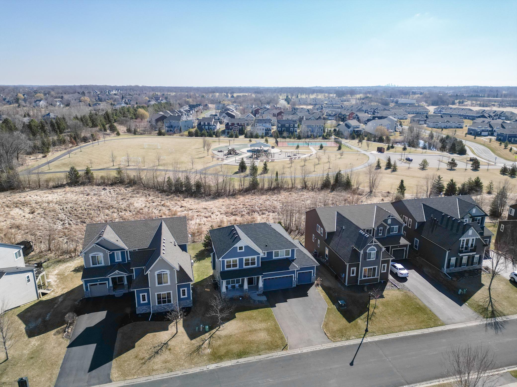 Expansive aerial view capturing the surrounding neighborhood, open space, and thoughtfully planned community
