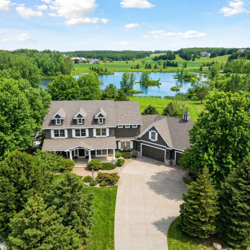 Stunning Gurtek Custom Homes craftsmanship inspired by a Kyle Hunt design, the craftsmanship shines in this striking aerial view, showcasing the estates signature roofline, dormerwindows and timeless curb appeal nestled among mature trees.