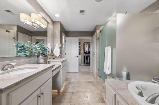 Through the door your connecting oversized his and hers closet offers all the space you want.