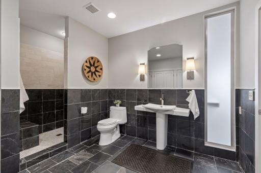 This was built as a massive stone and tile bath designed to easily handle all of the poolside activity.
