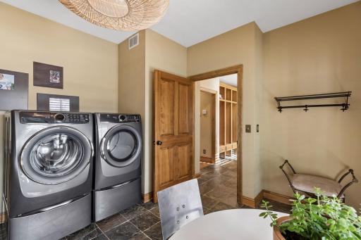 This laundry space offers new appliances and has plenty of room to create a craft or project space.