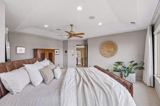This private primary suite is expansive and has plenty of space for a sitting area and chase lounger