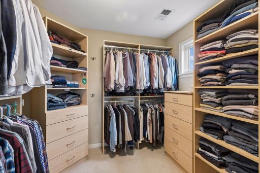 The primary closet offers custom closet systems