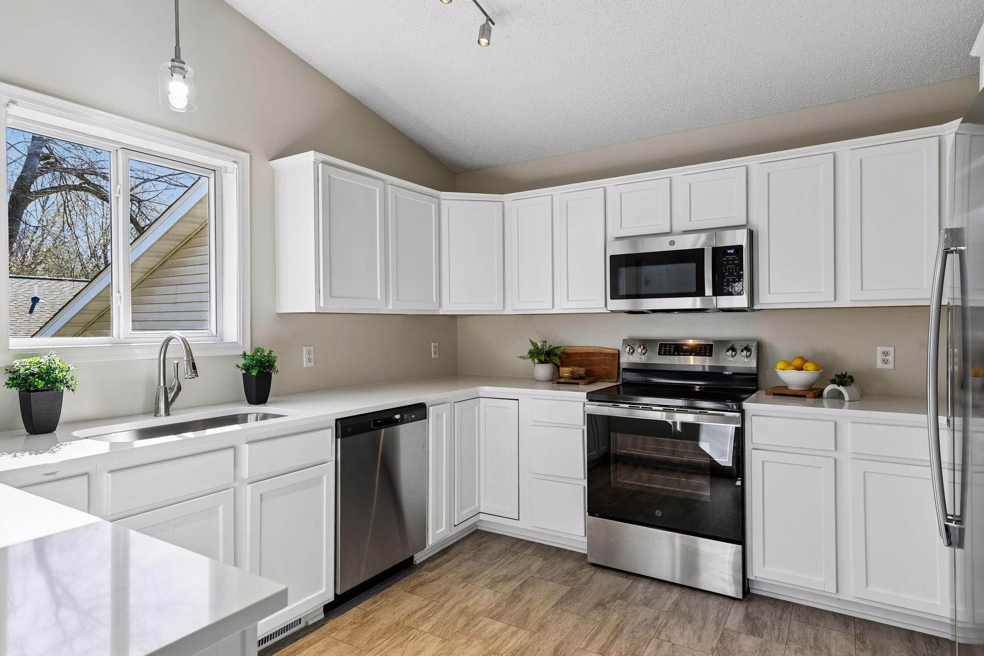 New stainless-steel appliances await to be used for the first time in this crisp white kitchen.