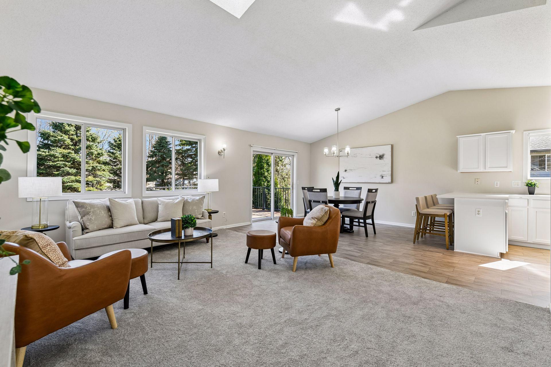 Open flow with vaulted ceilings for living room with wall of windows open to kitchen. Enjoy this turnkey home.