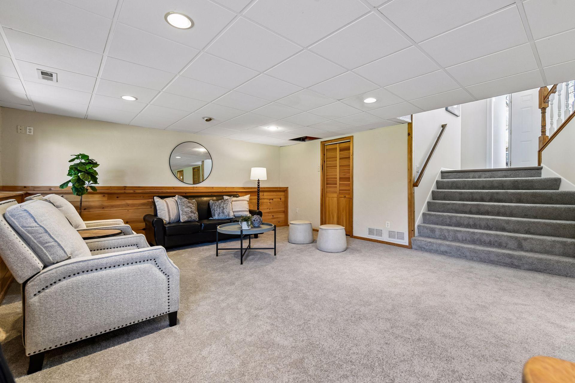 Lower level with utility room / laundry behind door. Nice, elongated stairs that flow from the front door open to spacious lower level with look out windows.