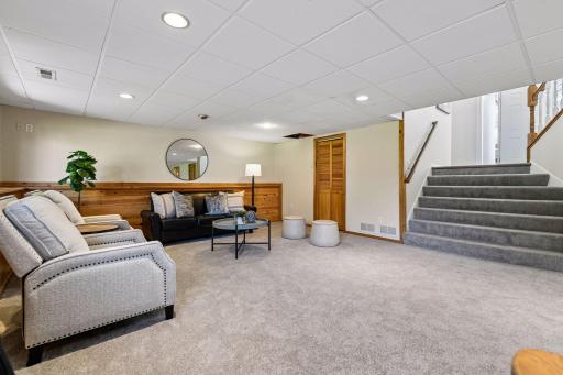 Lower level with utility room / laundry behind door. Nice, elongated stairs that flow from the front door open to spacious lower level with look out windows.