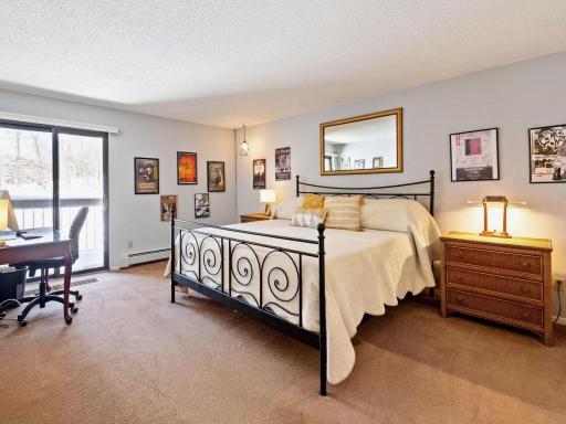 Primary bedroom suite with private balcony and ensuite bathroom.