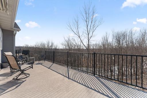 Composite deck & retractable SunSetter awning with tranquil wooded surroundings and seasonal views of Upper Prior Lake