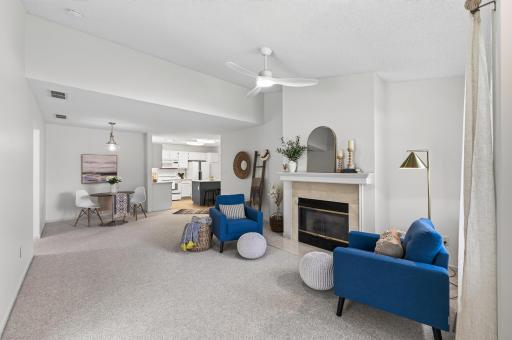 The sunny living room with cozy fireplace will be the place to gather and make memories.