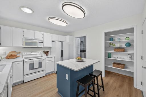 The modern quartz countertop on the island is the perfect place to grab a quick breakfast and go.