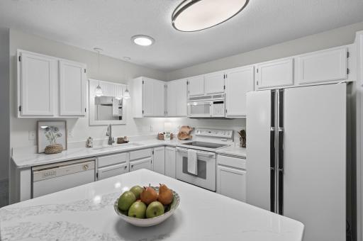 Newly refreshed with quartz countertops, fresh paint, new lighting and brand new wide-plank luxury vinyl plank flooring. The solar tube keeps this kitchen bright and sunny.