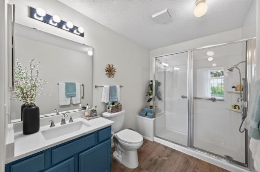 Updated primary bath with new walk-in shower, flooring, quartz countertops and fresh paint.
