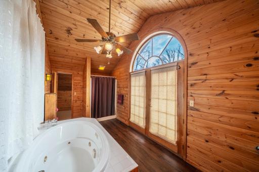 Bathroom features jetted tub and balcony.