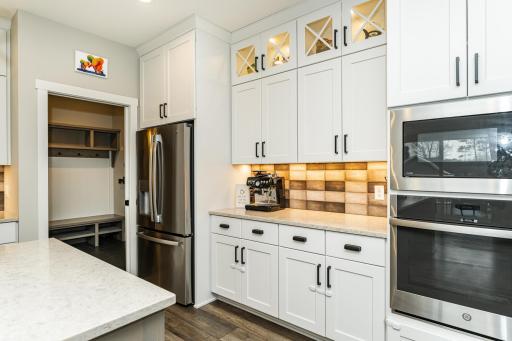 Coffee bar area and floor to ceiling lighted cabinetry