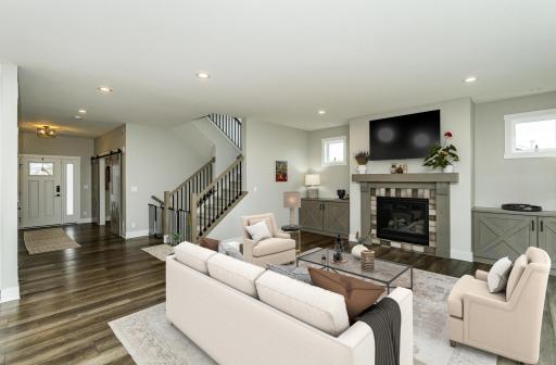 Family room with gas fireplace, transom windows, and storage to both sides