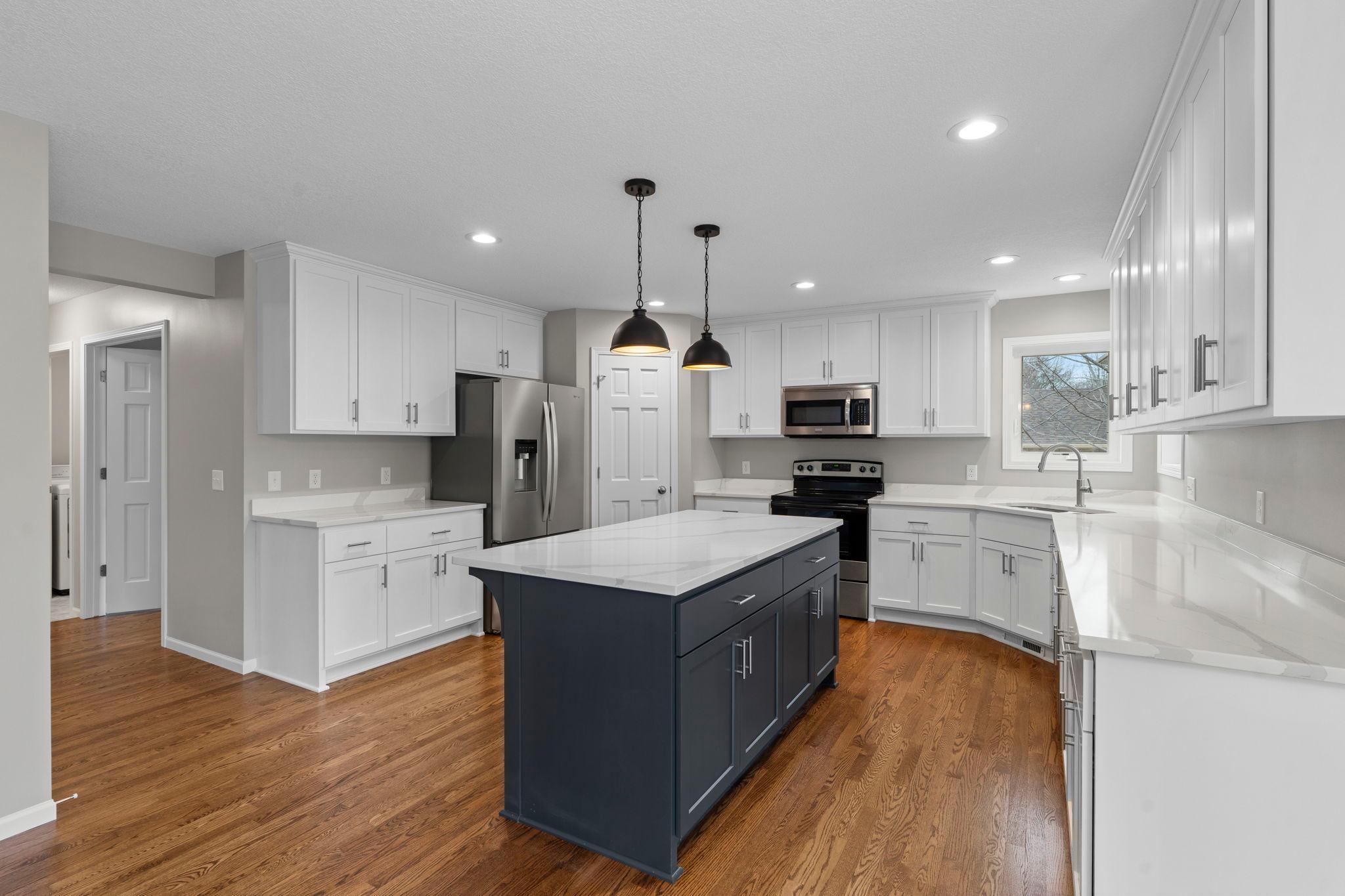 Brand new kitchen! Cabinets, island, and quartz countertops. Beautifully designed! Stylish kitchen island with a pop of color and convenient breakfast bar.