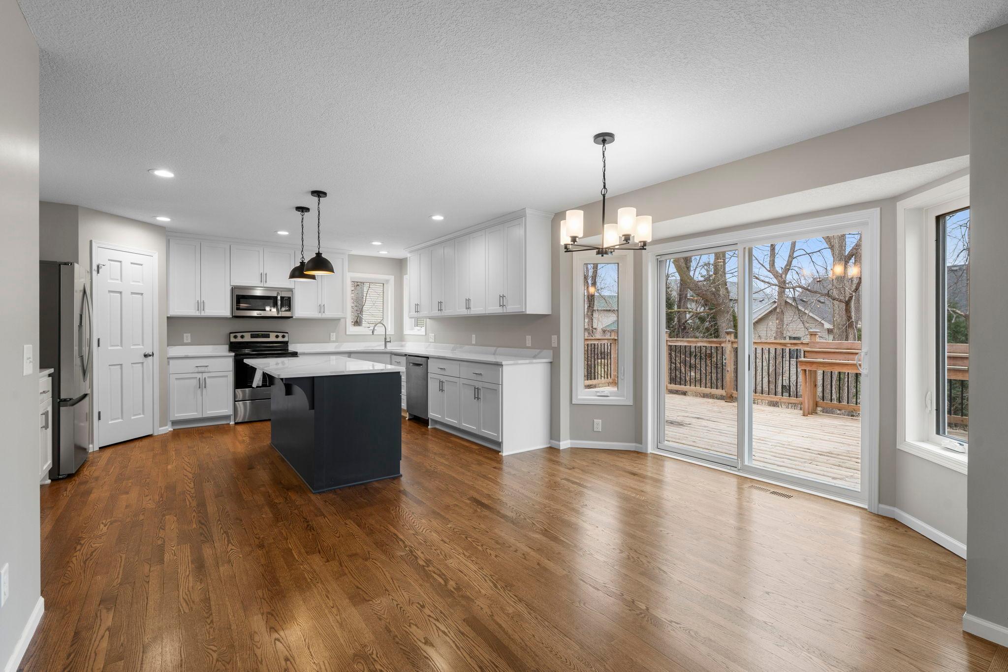 Gorgeous refinished hardwood floors! Spacious informal dining walks out to large deck.