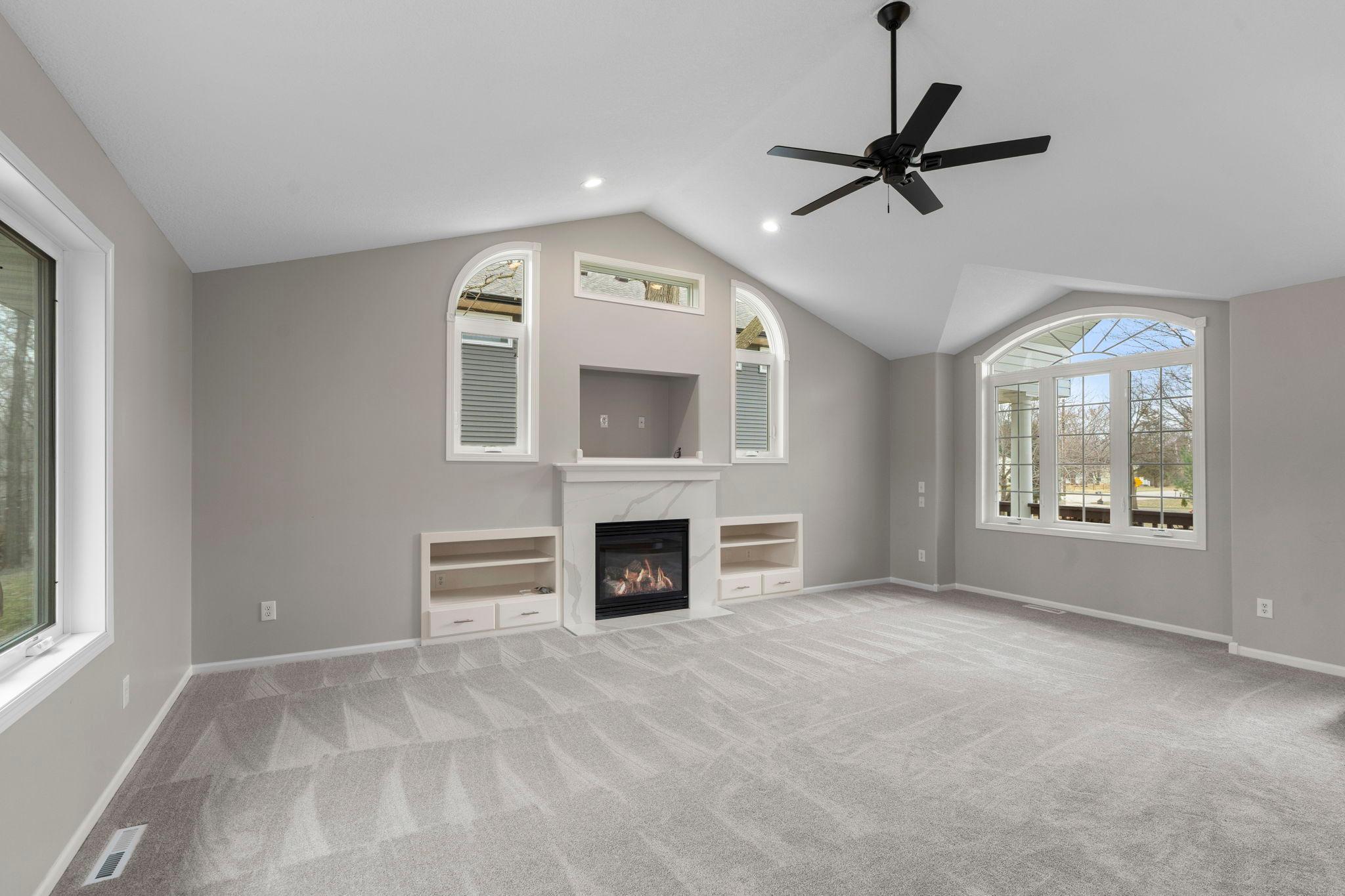 Light fills this space with large windows on both side of this cozy living room.
