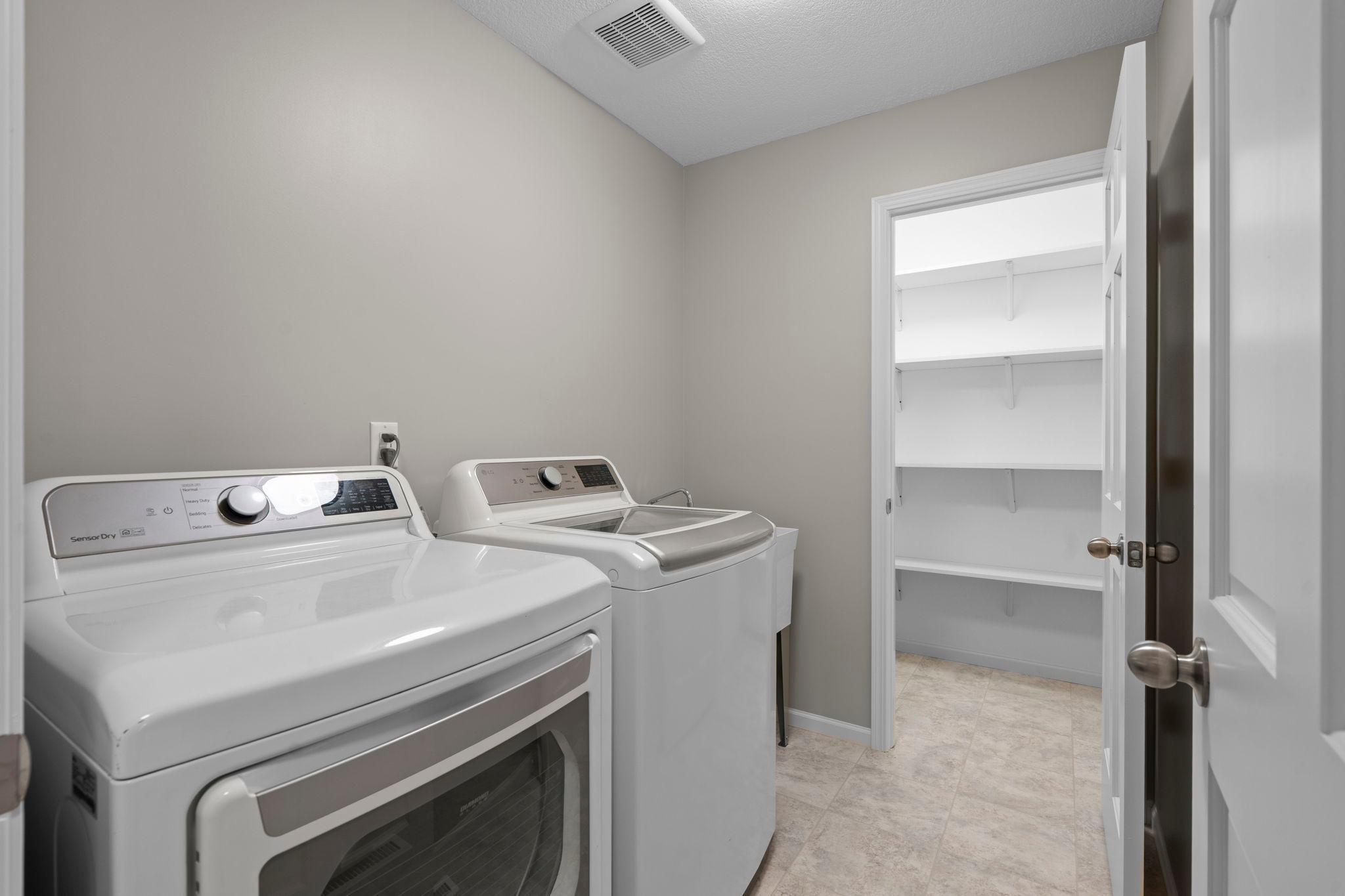 Awesome main level laundry with large storage closet.