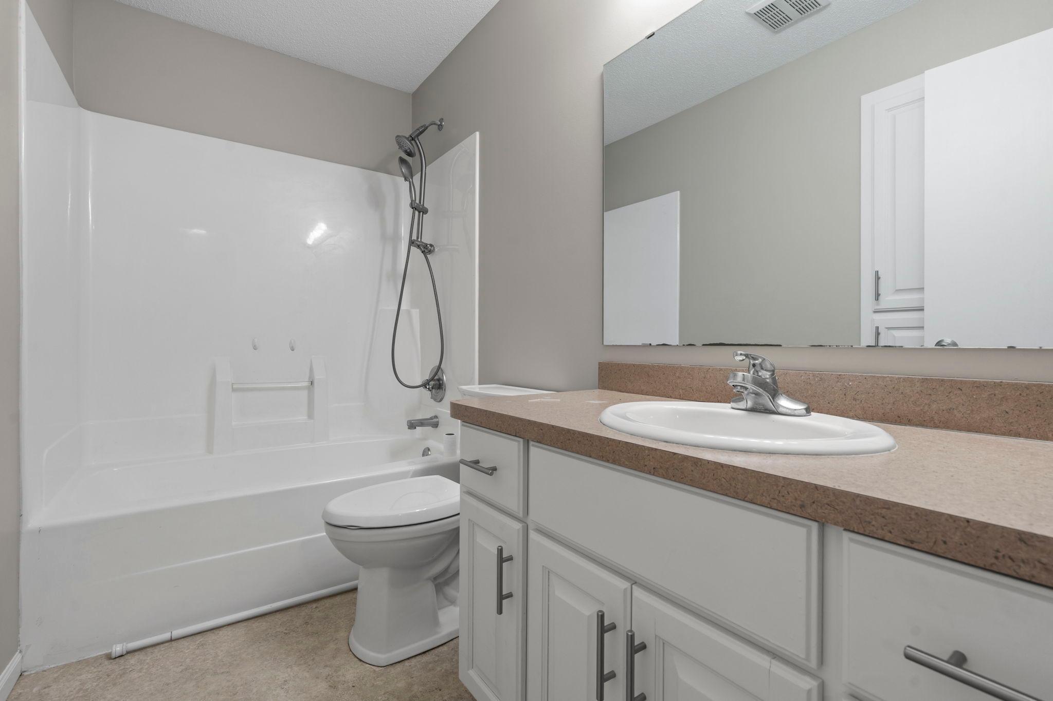 Full bathroom on the upper level with oversized vanity.