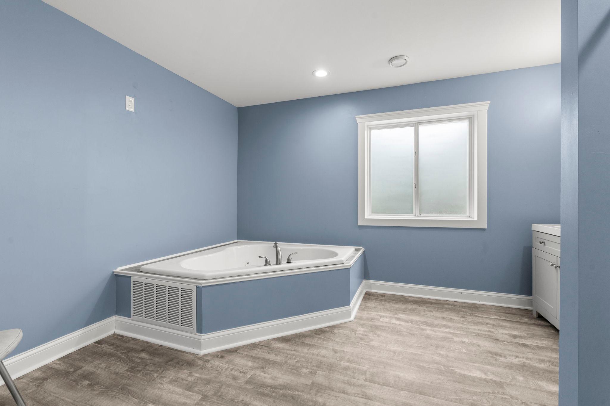 Incredible bathroom space in the lower level offering for amazing basement setup. Jacuzzi tub, updated floors, stylish modern trim.