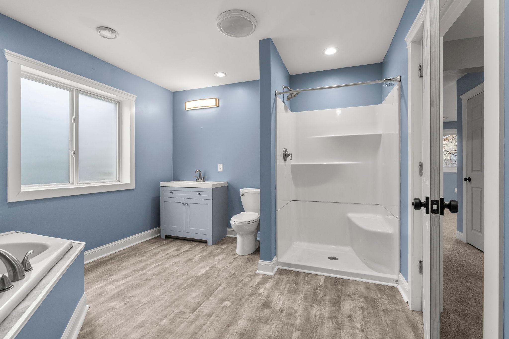 Incredible bathroom space in the lower level offering for amazing basement setup. Jacuzzi tub, updated floors, stylish modern trim.