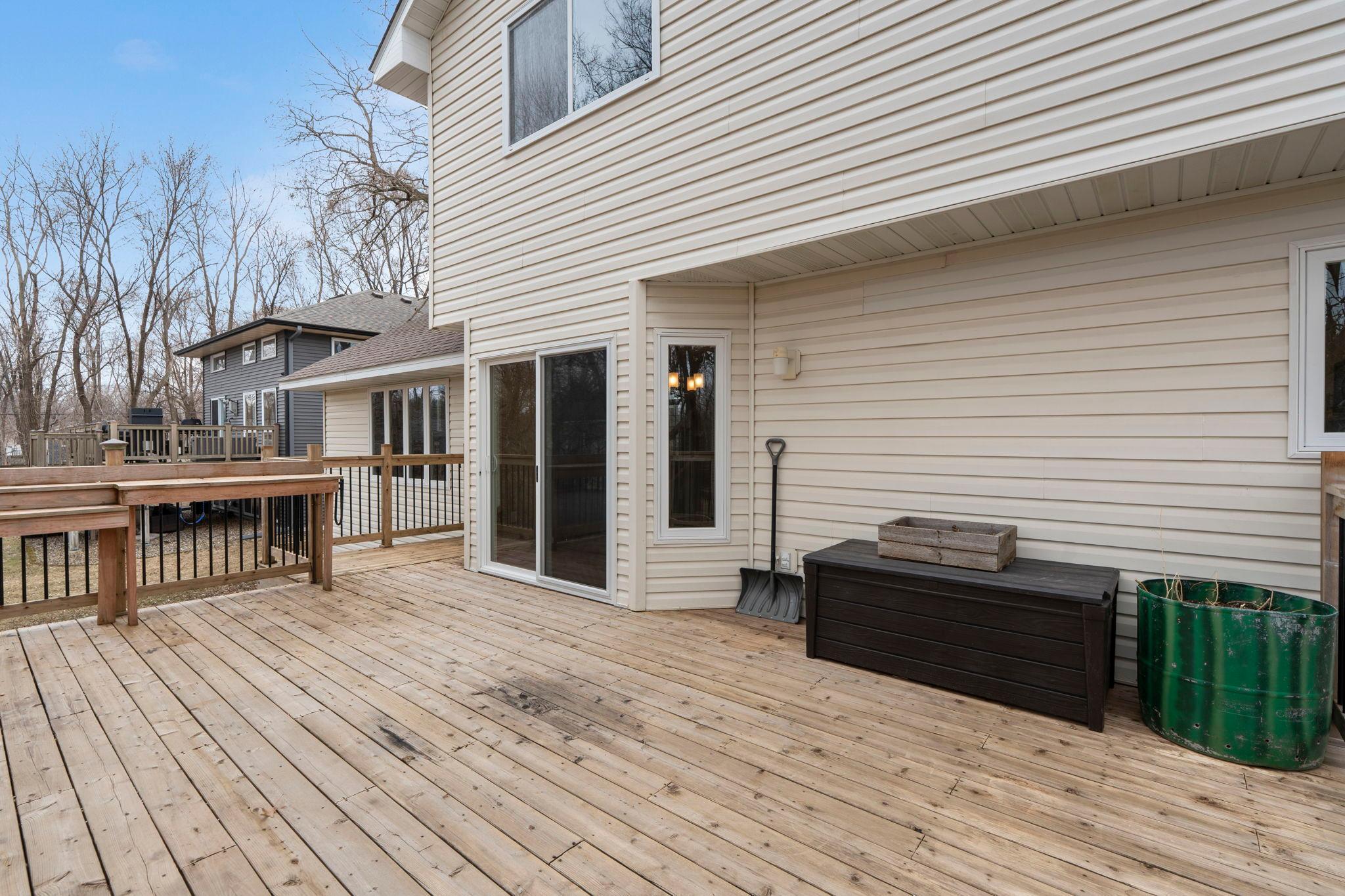 Large back deck and tree-lined backyard.