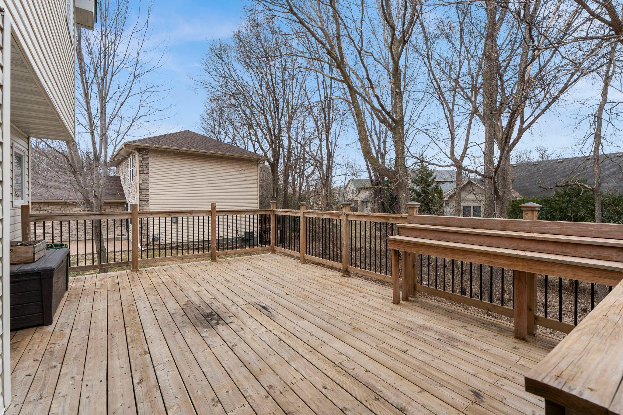 Large back deck and tree-lined backyard.