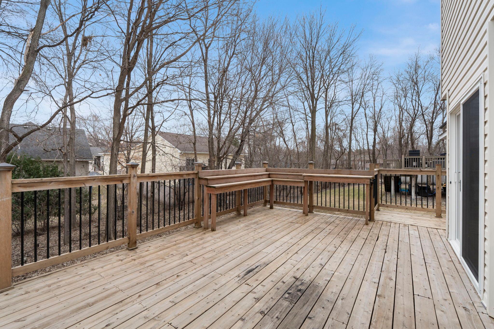 Large back deck and tree-lined backyard.