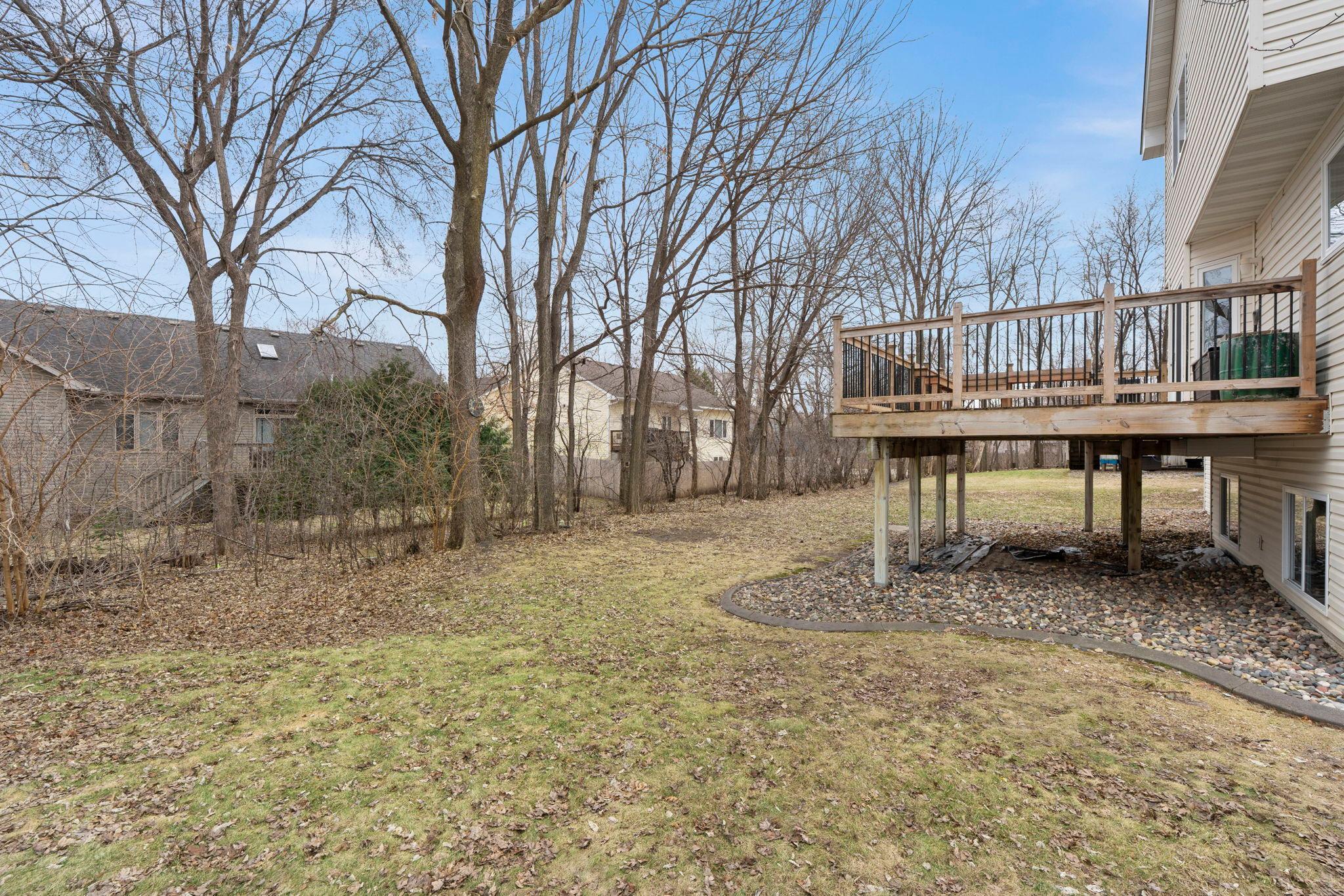 Tree-lined backyard! Awesome deck retreat.