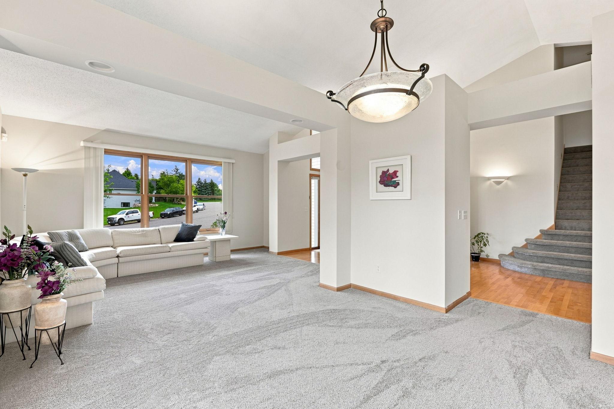 Main floor living room with vaulted ceilings really lights up this home