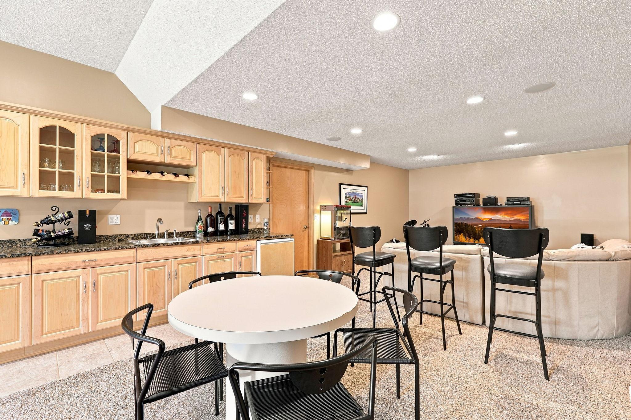 The expansive basement has a wet bar area and is an entertainers delight