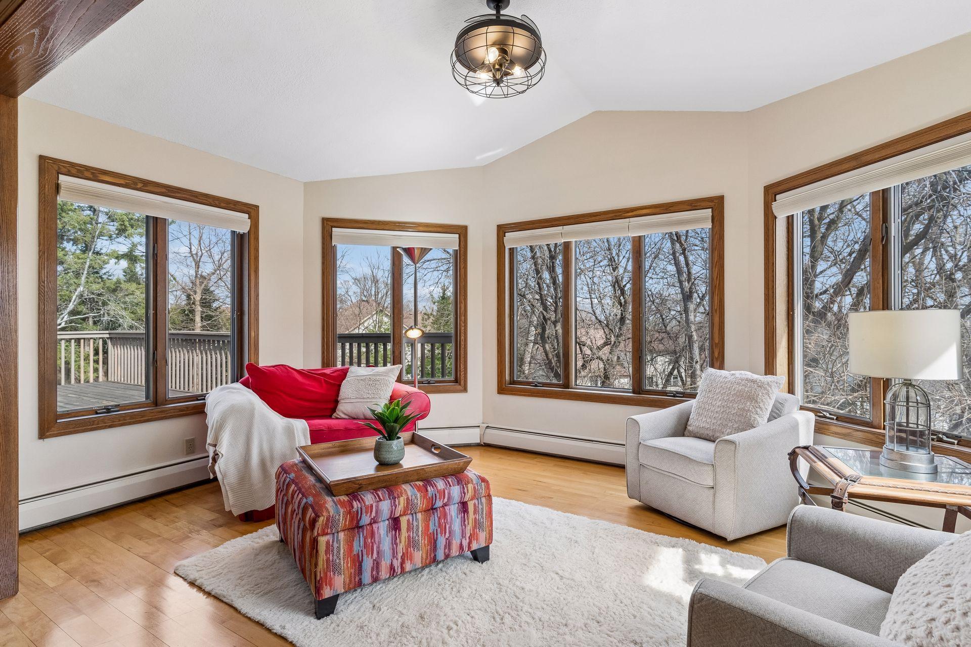 Sun Room with walls of windows overlooking the backyard.