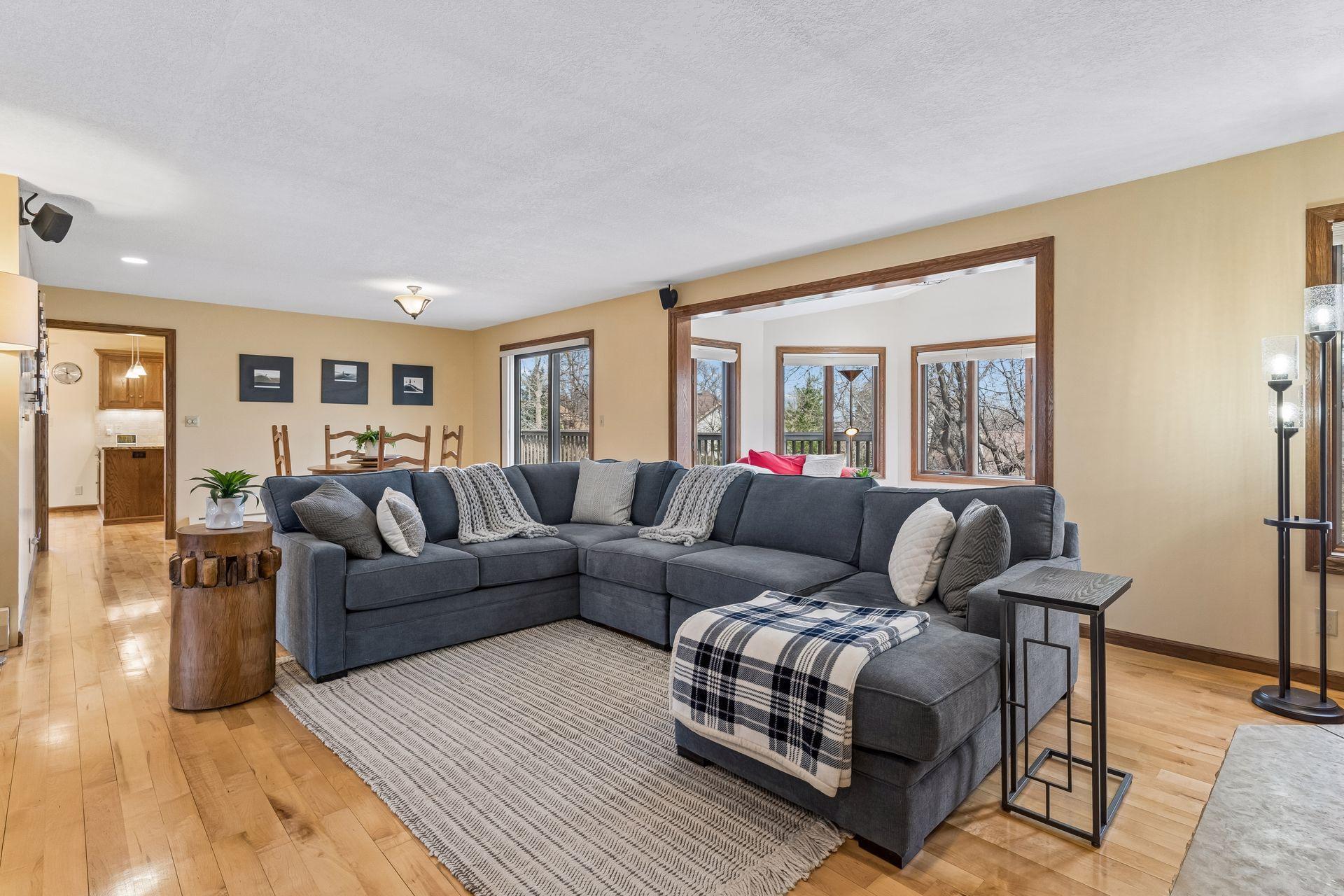 Living Room flows into Sun Room and Dining area.