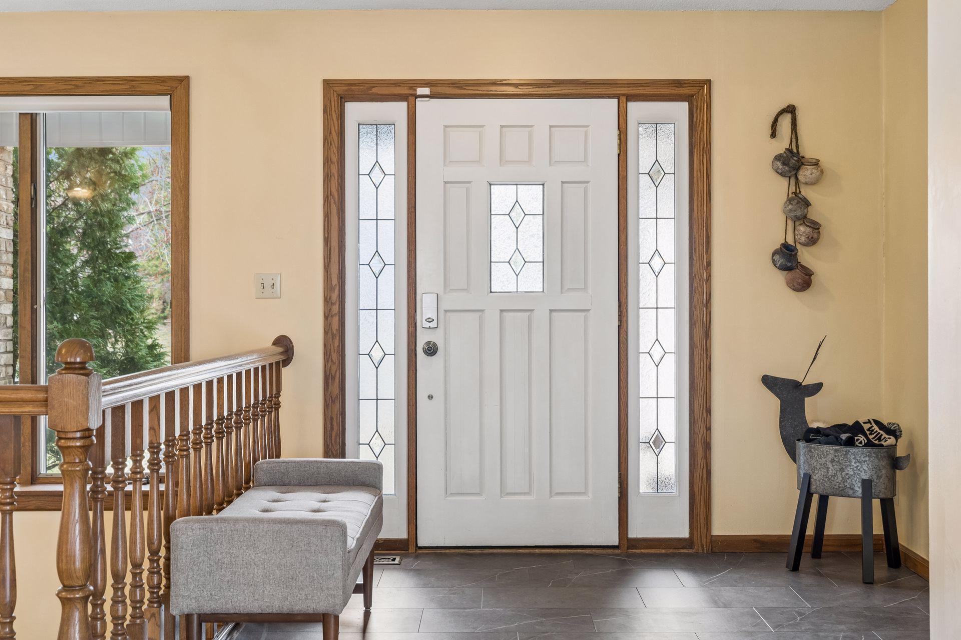 Welcoming entry with sidelight windows for natural light and newer LVP flooring.