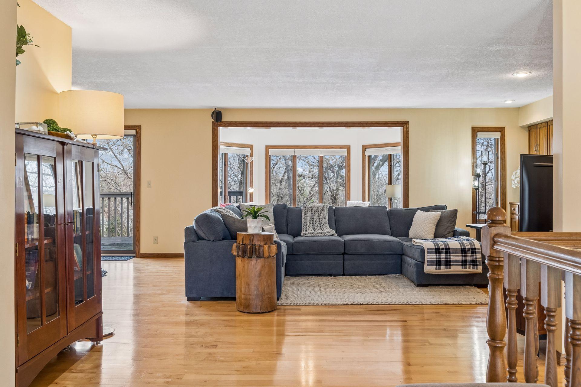 Open Living Room with maple wood floors and large windows.