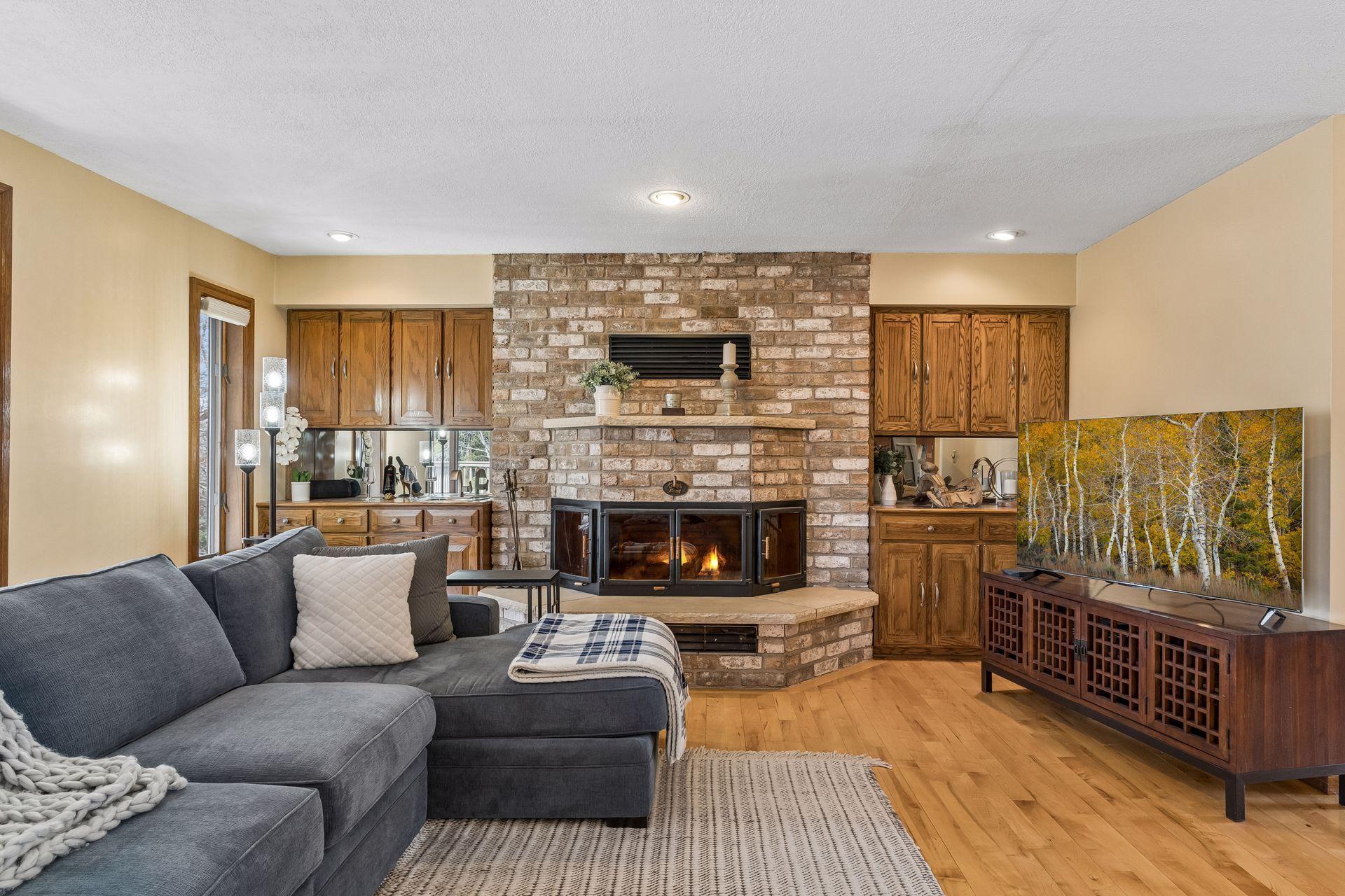 Unique three-sided fireplace as the centerpiece of the Living Room with built-ins on both sides including a wet bar.