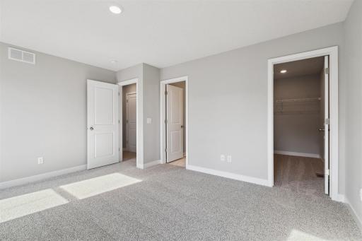 The very generous primary bedroom has plenty of space to fit your dream furniture set. Bedroom fits king-size furniture. Photo of Model Home. Options and colors may vary. Ask Sales Agent for details.