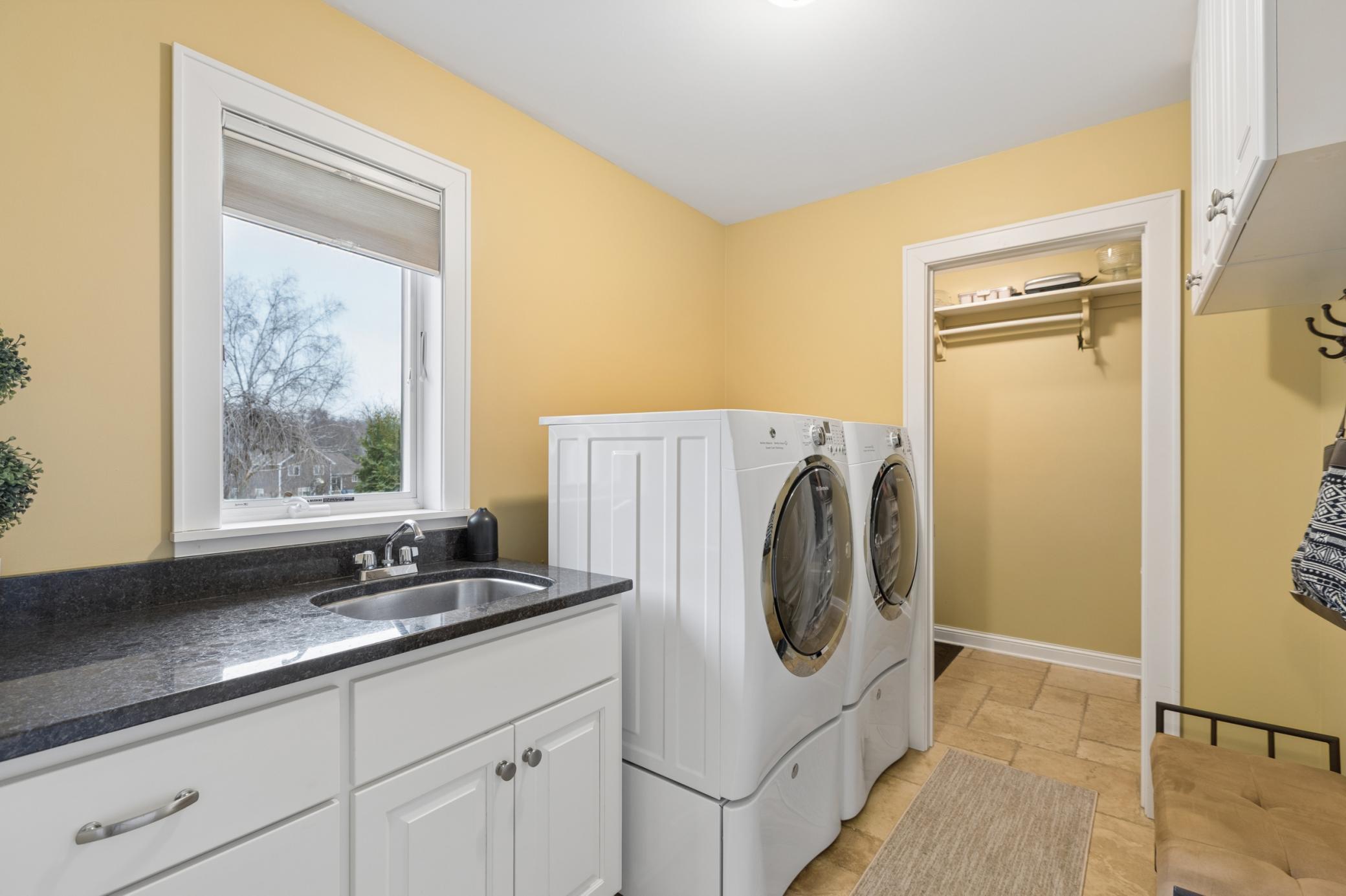 The main level also features a laundry room with a nice sized sink and large pantry or storage room. Thoughtfully located off the entry from the main garage to not track messes through the house.