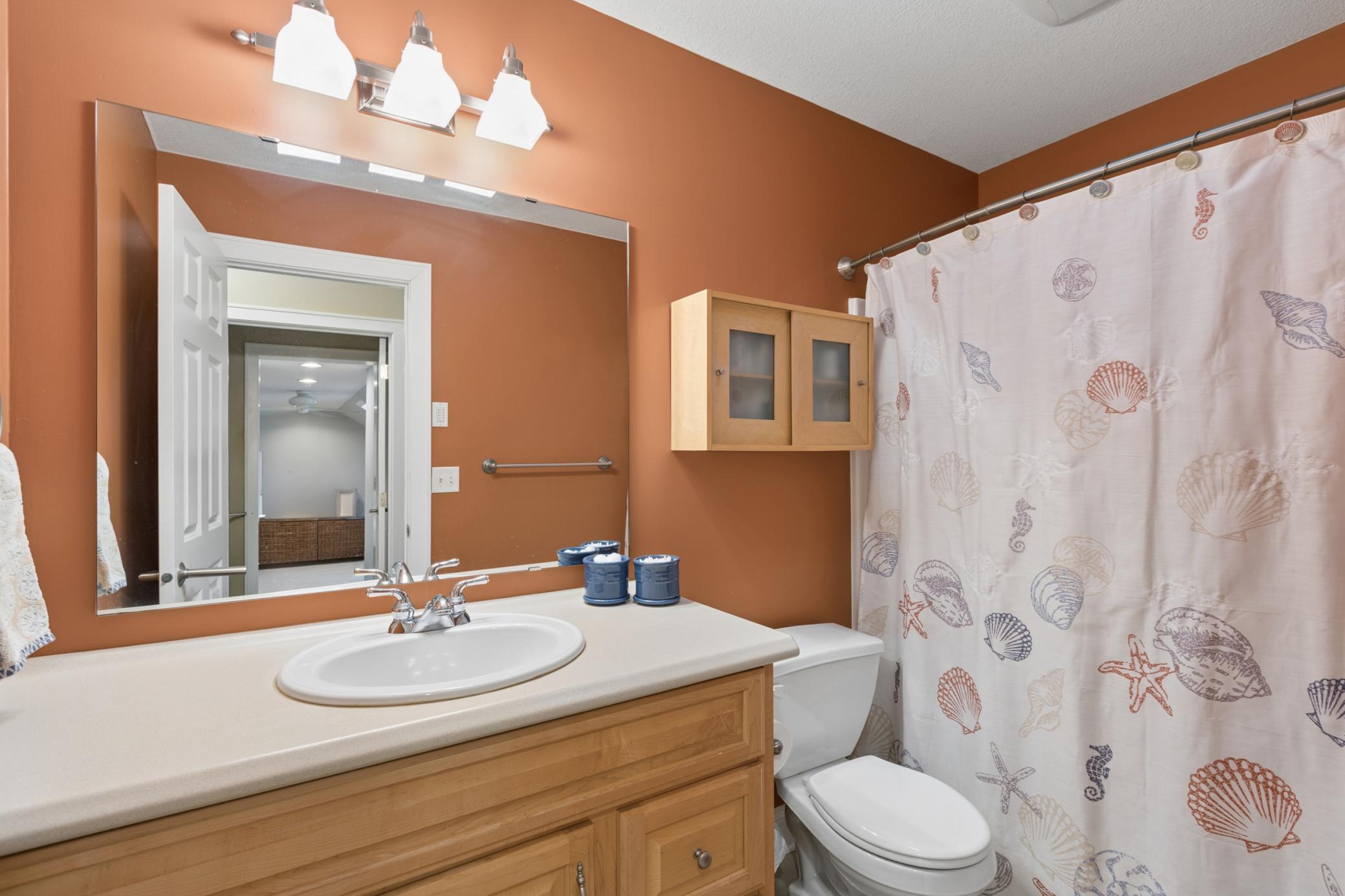 View of the upper-level full bathroom, centrally located between the upper-level bedrooms.
