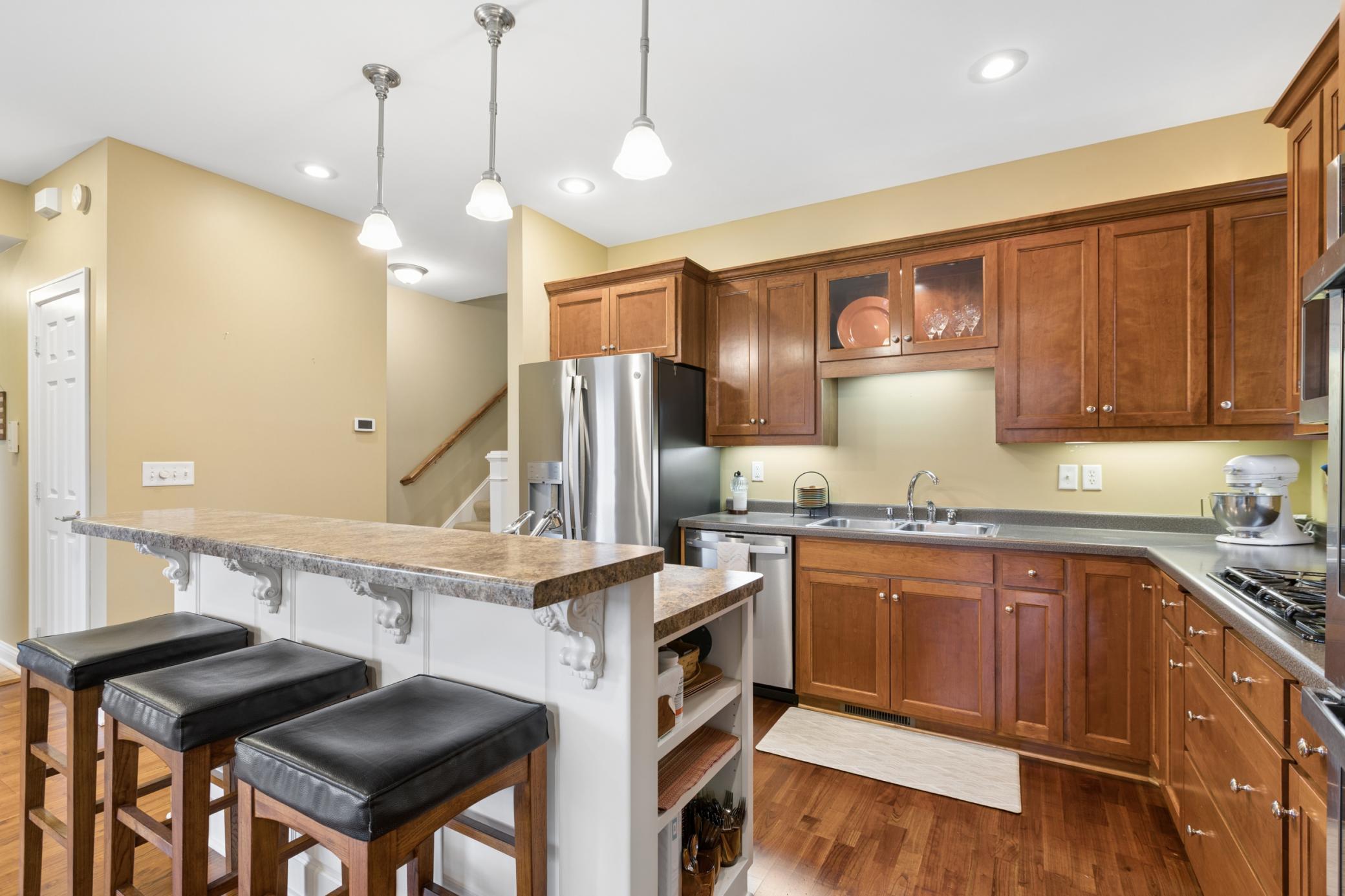 With dual wall ovens that can be controlled by your phone along with a gas cooktop this kitchen will be a joy to prepare meals for family or friends and has plenty of prep space and storage.