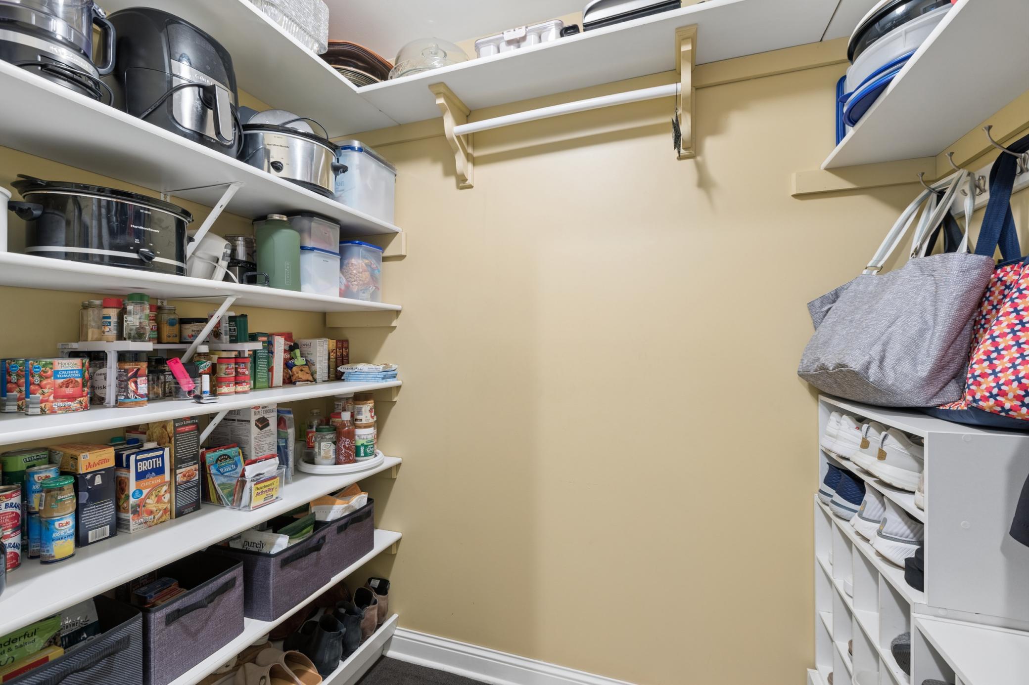 View of the walk-in pantry/closet for extra storage space off the main floor laundry room.
