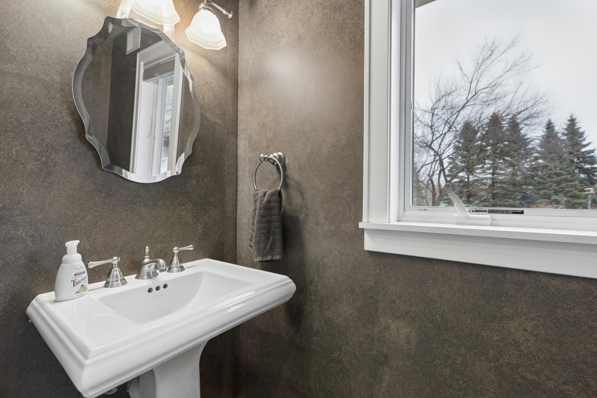 Located between the attached garage and informal dining room is a half bath.