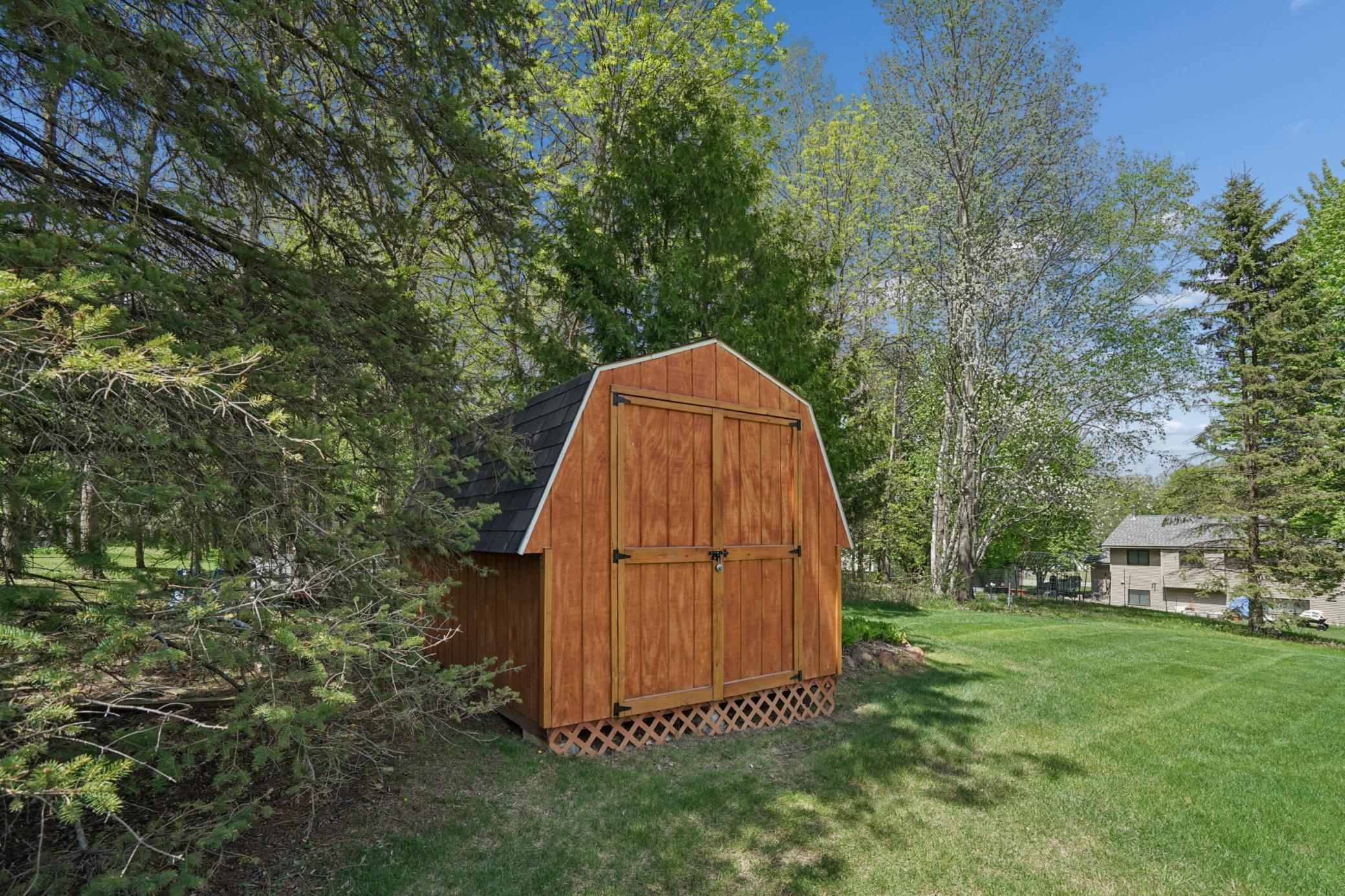 In the backyard there is a storage shed for all of your garden tools, lawn mower and yard toys. This is a great addition to keep the attached three stall garage neat and tidy.