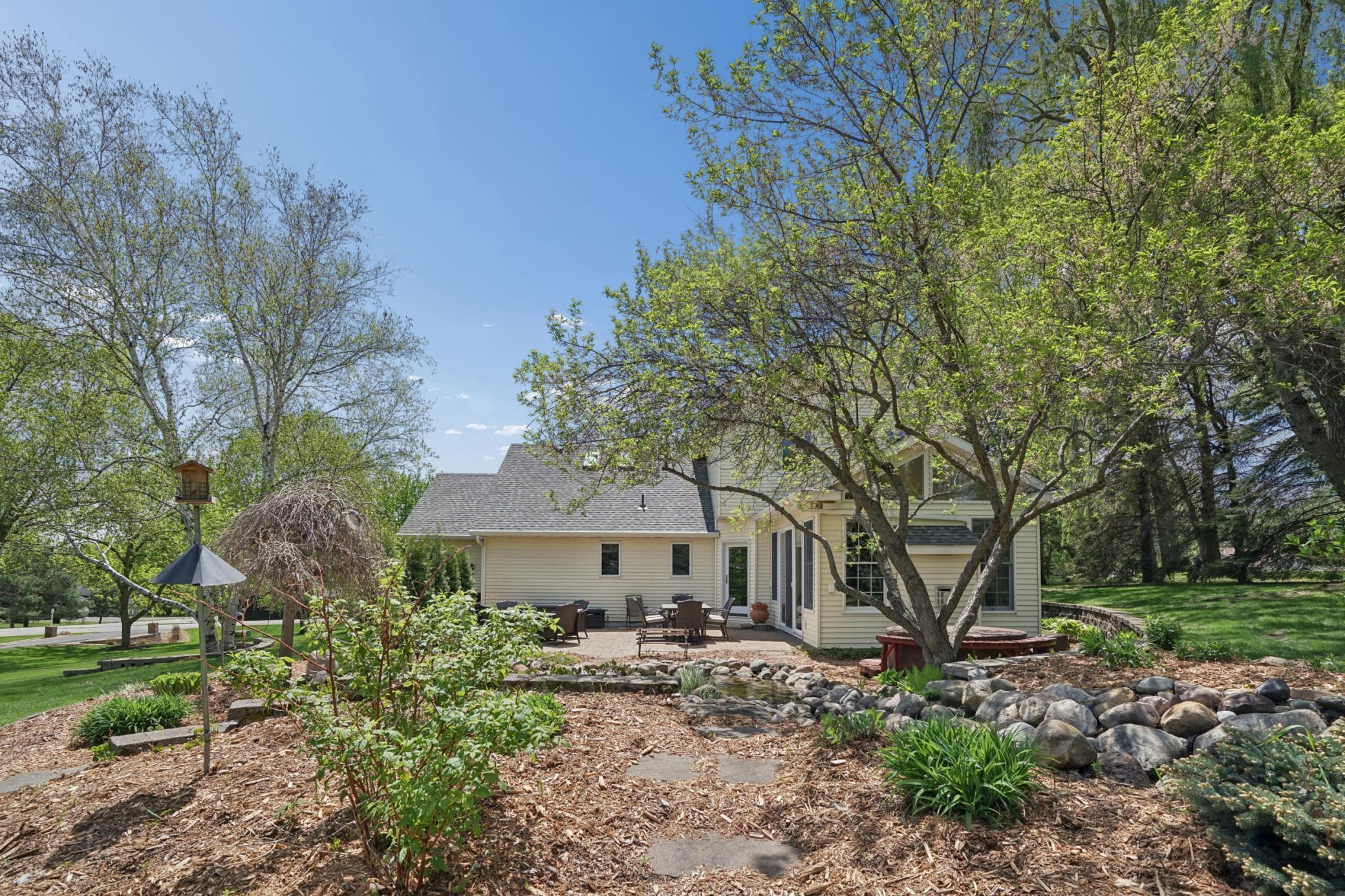 View of the stepping stones through garden up to the koi pond with waterfall feature. This property is surrounded by nature and you will frequently see deer and a variety of birds.