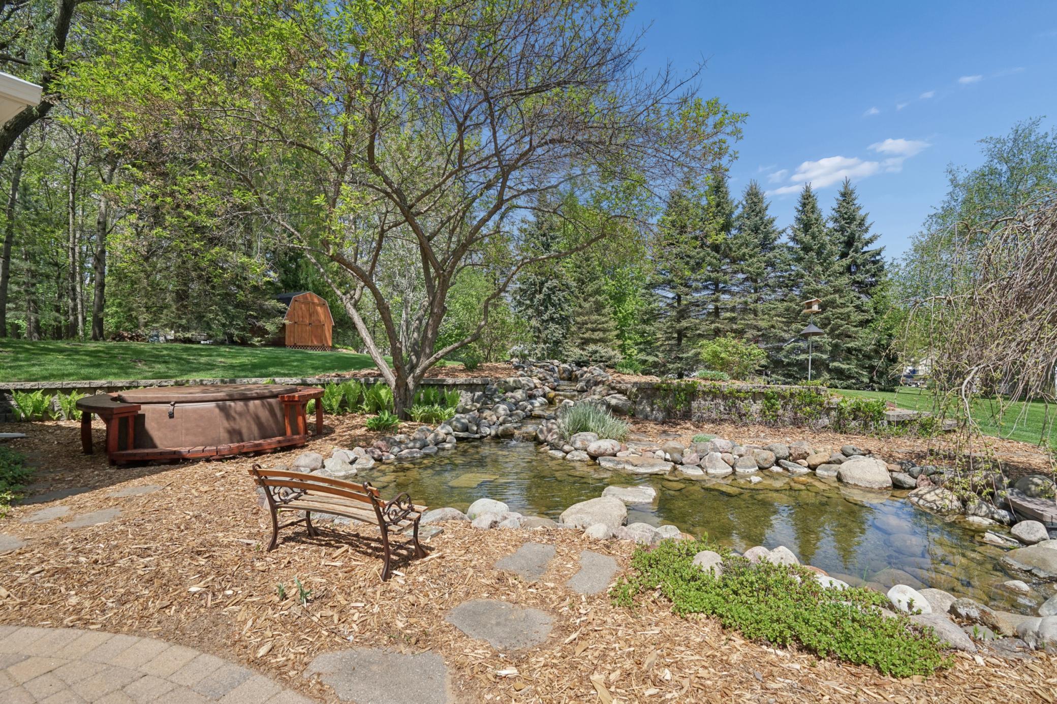 View of the tranquil pond with the perfect spot for a hot tub for the ultimate relaxation. The pond is plumbed into the irrigation system that has its own well to bring fresh water into the pond to keep things clear and clean.
