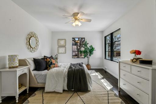The second bedroom on the main level features hardwood flooring and two closets with custom organizers.