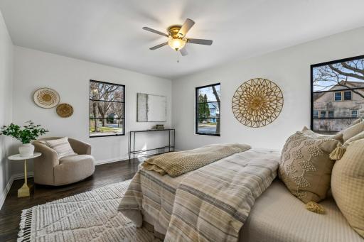 Escape after a long day to the main floor primary suite featuring hardwood flooring, two closets with custom organizers and a private bath
