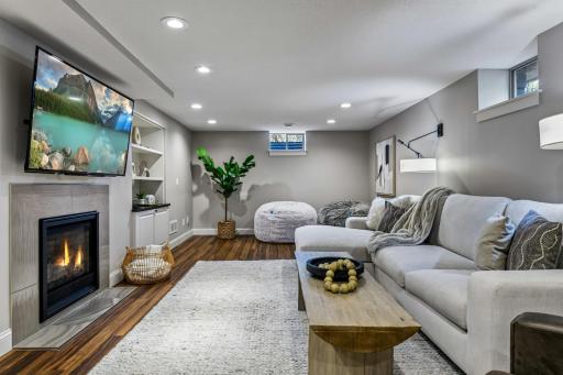 The family room features LVP flooring and cozy gas fireplace flanked by built-in cabinetry and bookcases